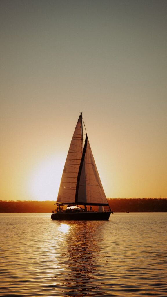 pexels-photo-7395353 Yacht sailing on river at sunset