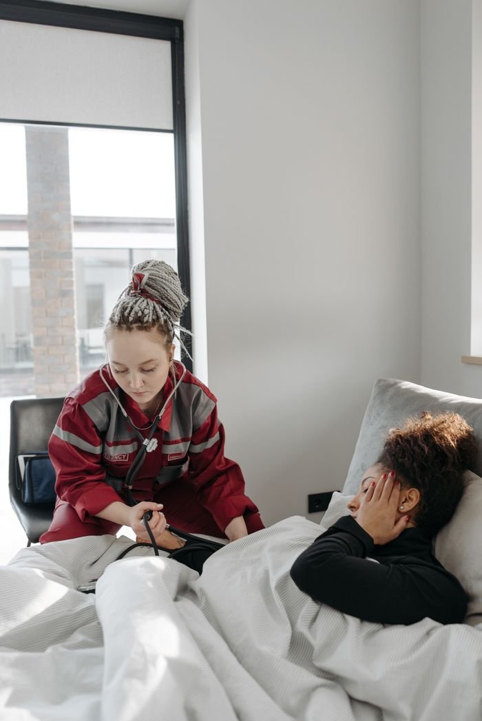 why-choose-us-img Paramedic providing healthcare assistance to a sick woman in a bright room.